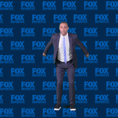 Man In Suit And Tie Dancing In Front Of Fox Deportes Background GIF