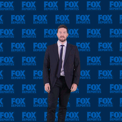 Man In Suit And Tie Dancing In Front Of Fox Deportes Background GIF