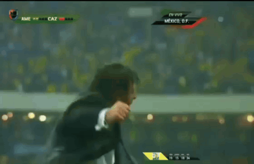 Man In Suit And Tie Dancing In Front Of Screen Saying Mexico GIF