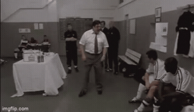 Man In Suit And Tie Dancing In Locker Room GIF