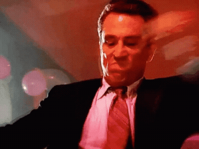 Man In Suit And Tie Dancing In Red Room GIF