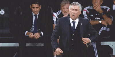 Man In Suit And Tie Dancing Near Seated Men GIF