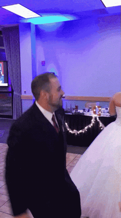 Man In Suit And Tie Dancing With Bride GIF