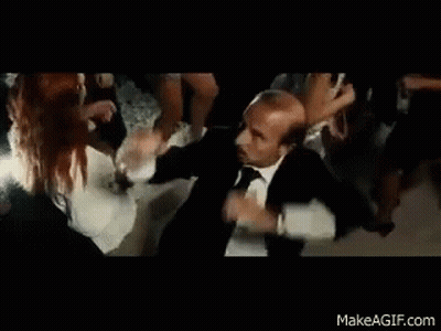 Man In Suit And Tie Dancing With Group GIF