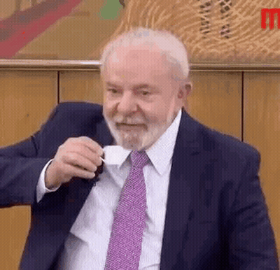 Man In Suit And Tie Drinking Coffee GIF