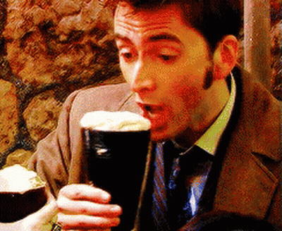 Man In Suit And Tie Drinking From Glass GIF