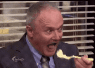 Man In Suit And Tie Eating Cheese With Spoon GIF