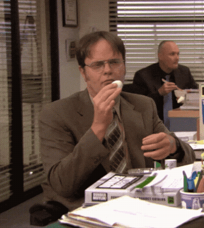 Man In Suit And Tie Eating Donut From Donut King Box GIF