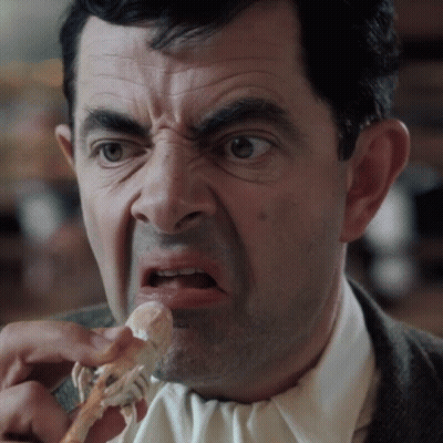 Man In Suit And Tie Eating Meat GIF