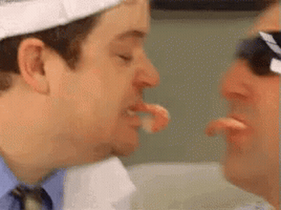 Man In Suit And Tie Eating Meat GIF