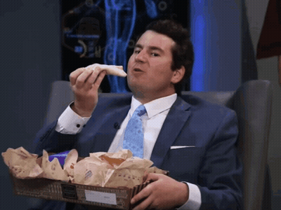 Man In Suit And Tie Eating Sandwich From Box GIF