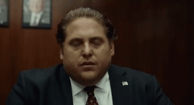 Man In Suit And Tie Eyes Closed Hand Out GIF