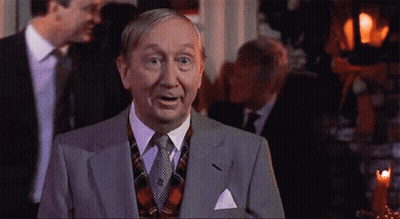 Man In Suit And Tie Facing Group GIF