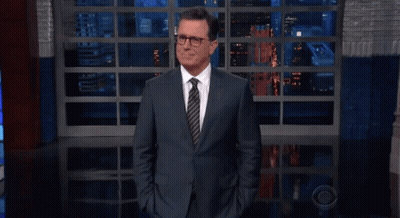 Man In Suit And Tie Hands In Pockets At Window GIF