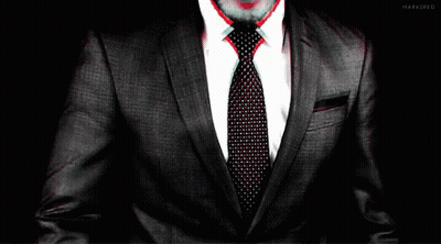 Man In Suit And Tie Hands On Chest GIF