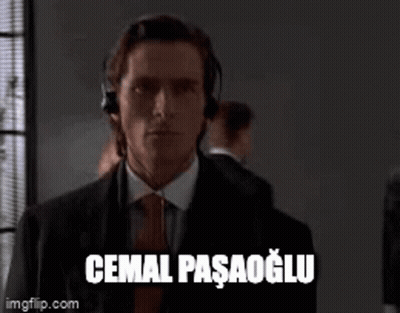 Man In Suit And Tie Headphones Saying Cemal Pasagolu GIF