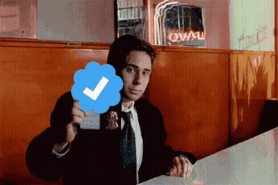 Man In Suit And Tie Holding Check Mark GIF