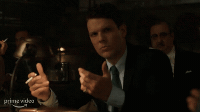 Man In Suit And Tie Holding Cigarette At Prime Video Sign GIF