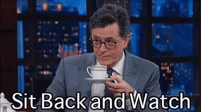 Man In Suit And Tie Holding Coffee Saying Sit Back And Watch GIF