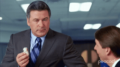 Man In Suit And Tie Holding Food GIF