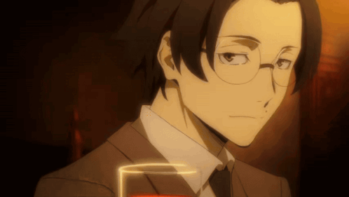 Man In Suit And Tie Holding Glass Of Red Liquid GIF
