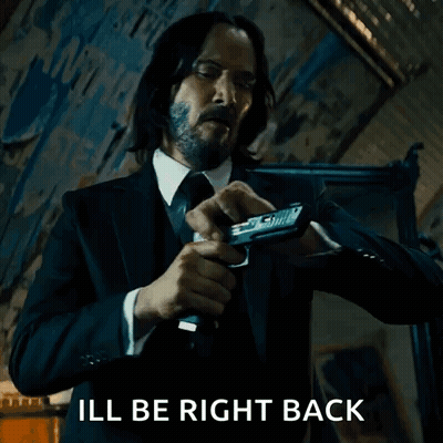 Man In Suit And Tie Holding Gun GIF