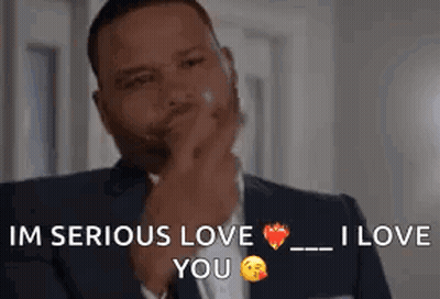 Man In Suit And Tie Holding Hand To Chin GIF