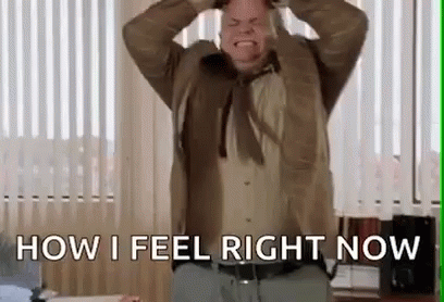 Man In Suit And Tie Holding Head And Screaming GIF