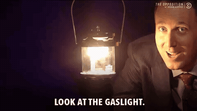 Man In Suit And Tie Holding Lantern Look At Gaslight GIF