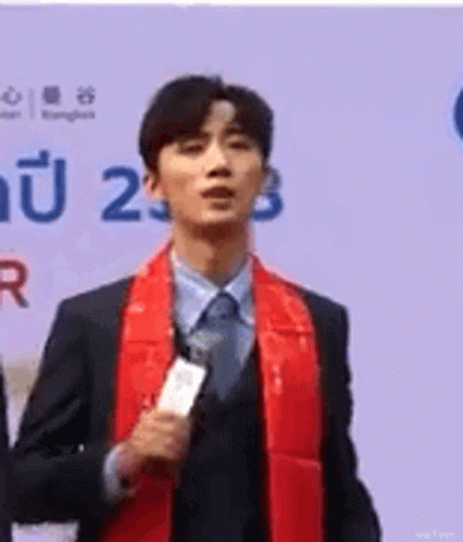 Man In Suit And Tie Holding Microphone GIF