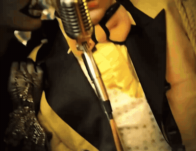 Man In Suit And Tie Holding Microphone GIF