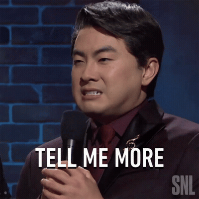 Man In Suit And Tie Holding Microphone GIF