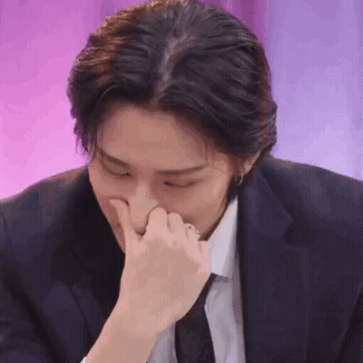 Man In Suit And Tie Holding Nose GIF
