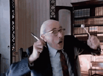Man In Suit And Tie Holding Pen And Hammer GIF