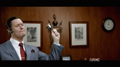 Man In Suit And Tie Holding Pen Near Clock Saying Much GIF