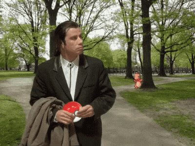 Man In Suit And Tie Holding Red Object GIF