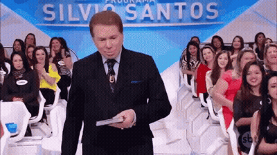 Man In Suit And Tie Holding Silva Santos Sign GIF