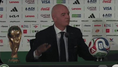Man In Suit And Tie Holding Soccer Ball At Qatar Airways GIF