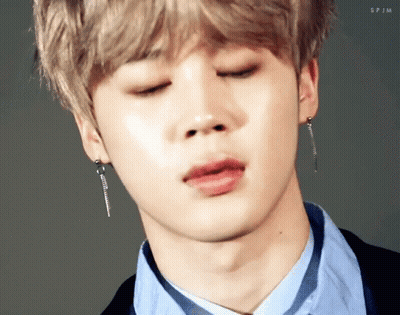 Man In Suit And Tie Holding Something GIF