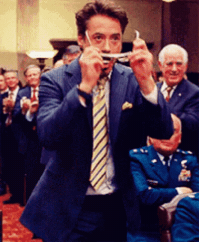 Man In Suit And Tie Holding Something GIF