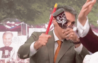 Man In Suit And Tie Holding Texas Tech Cup GIF