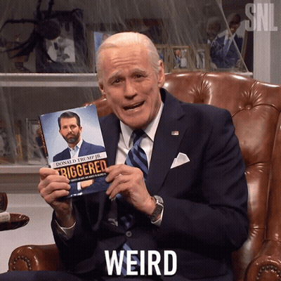 Man In Suit And Tie Holding Triggered Book GIF