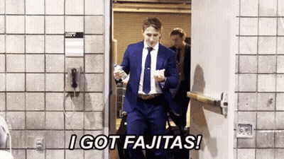 Man In Suit And Tie Holding Water Bottle In Doorway GIF