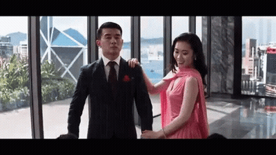 Man In Suit And Tie Holding Woman In Pink Dress GIF