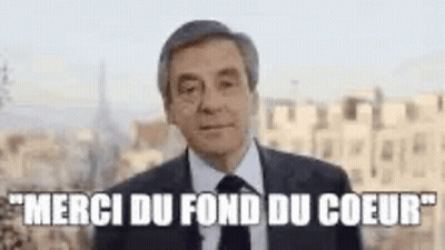 Man In Suit And Tie In City Says Merci Du Fond Du Coeur GIF