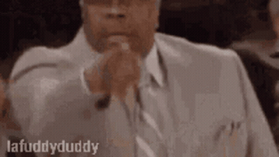 Man In Suit And Tie In Courtroom With Folded Hands GIF