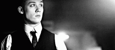 Man In Suit And Tie In Dark Room Black And White GIF