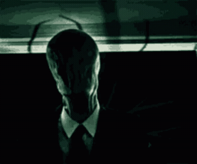 Man In Suit And Tie In Dark With Shadow GIF