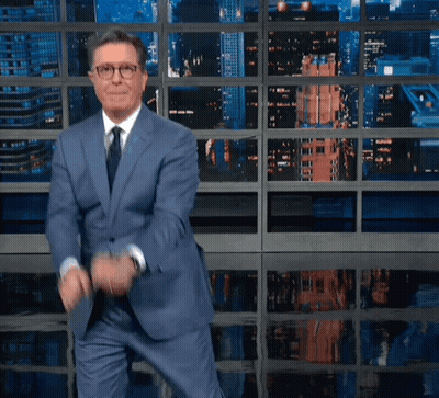 Man In Suit And Tie In Front Of Albert Rif Screen GIF