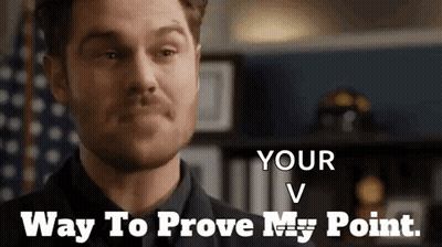 Man In Suit And Tie In Front Of American Flag GIF